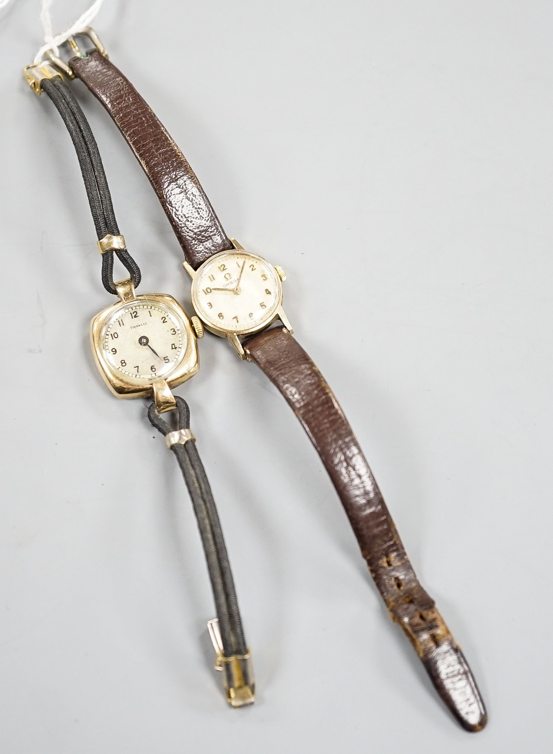 A lady's yellow metal Omega manual wind wrist watch, on leather strap and a similar 9ct Pinnacle watch.